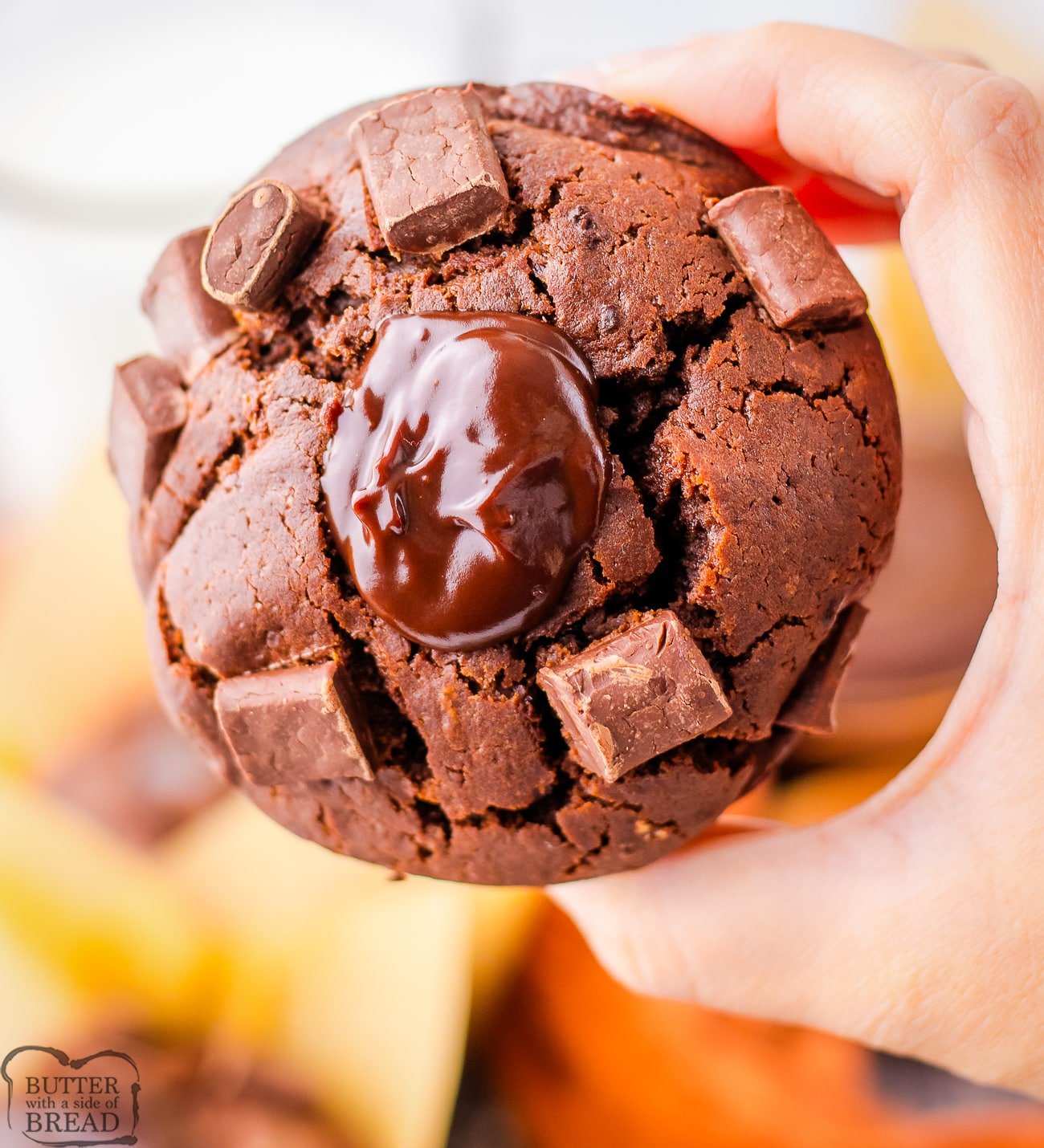 holding an Olympic village chocolate muffin 