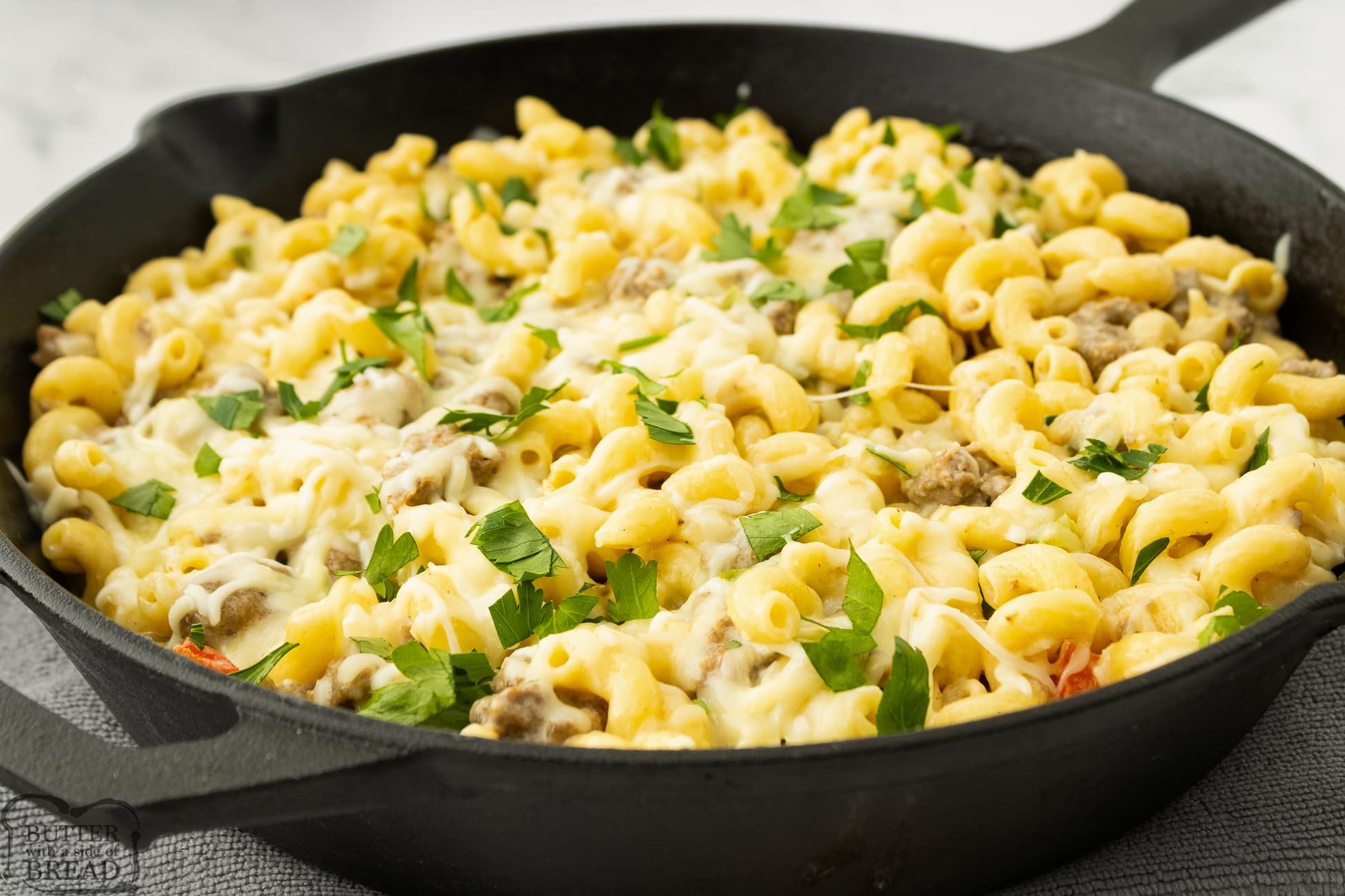 philly cheesesteak pasta in a cast iron skillet