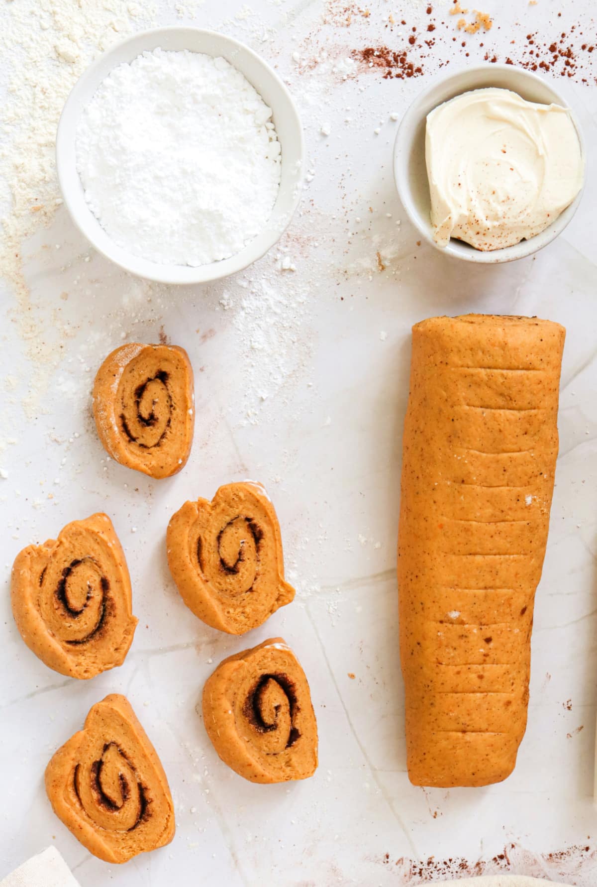 Slicing dough into 12 rolls. 