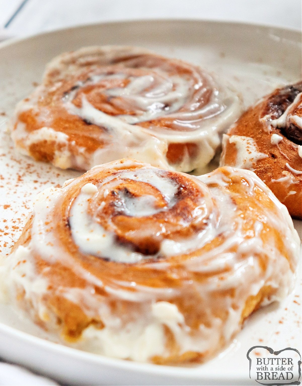 Pumpkin Cinnamon Rolls are light, soft, and packed with pumpkin flavor. These delicious cinnamon rolls are made completely from scratch with a simple cream cheese frosting.