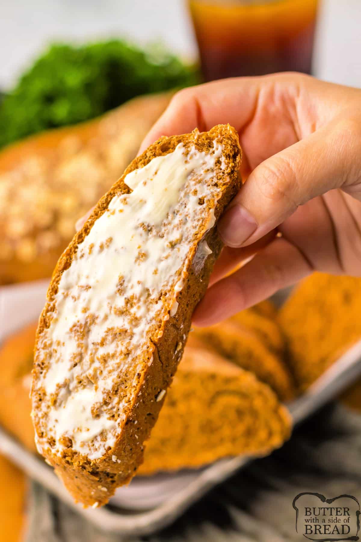 Slice of molasses bread with butter. 