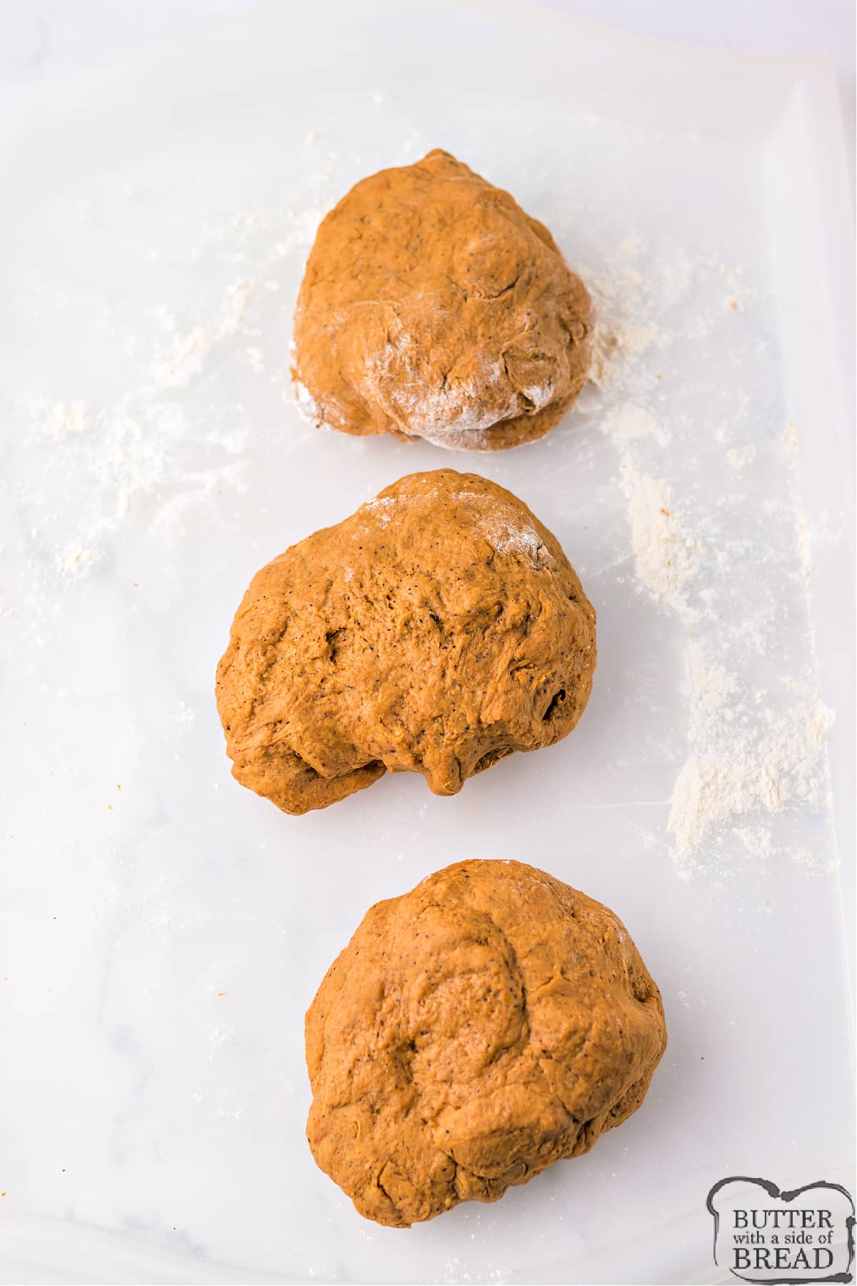 Bread dough separated into 3 portions. 