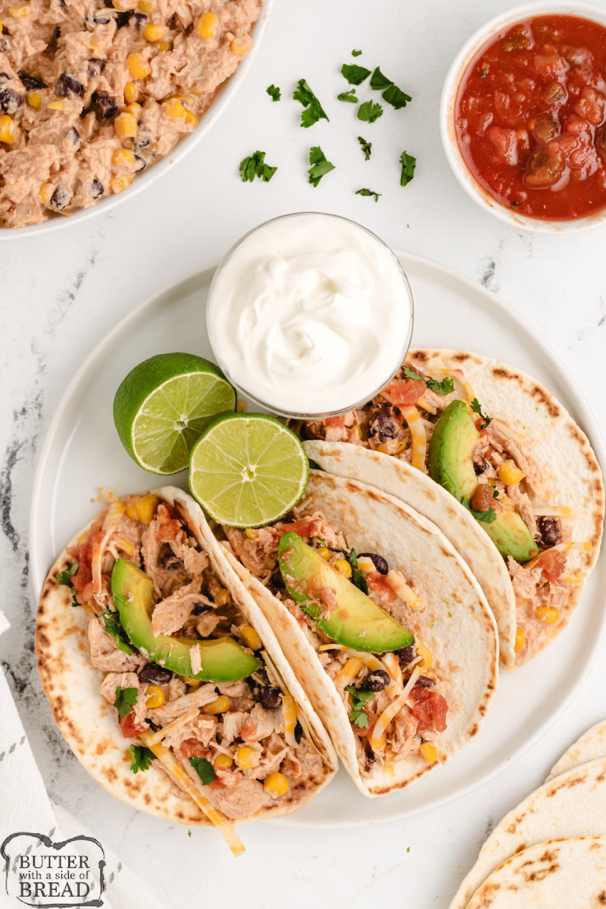 Crockpot Salsa Chicken Tacos is an easy weeknight dinner made with 5 ingredients and less than 5 minutes of prep time! Dump everything in the crockpot, turn it on, and dinner will be ready in a few hours!