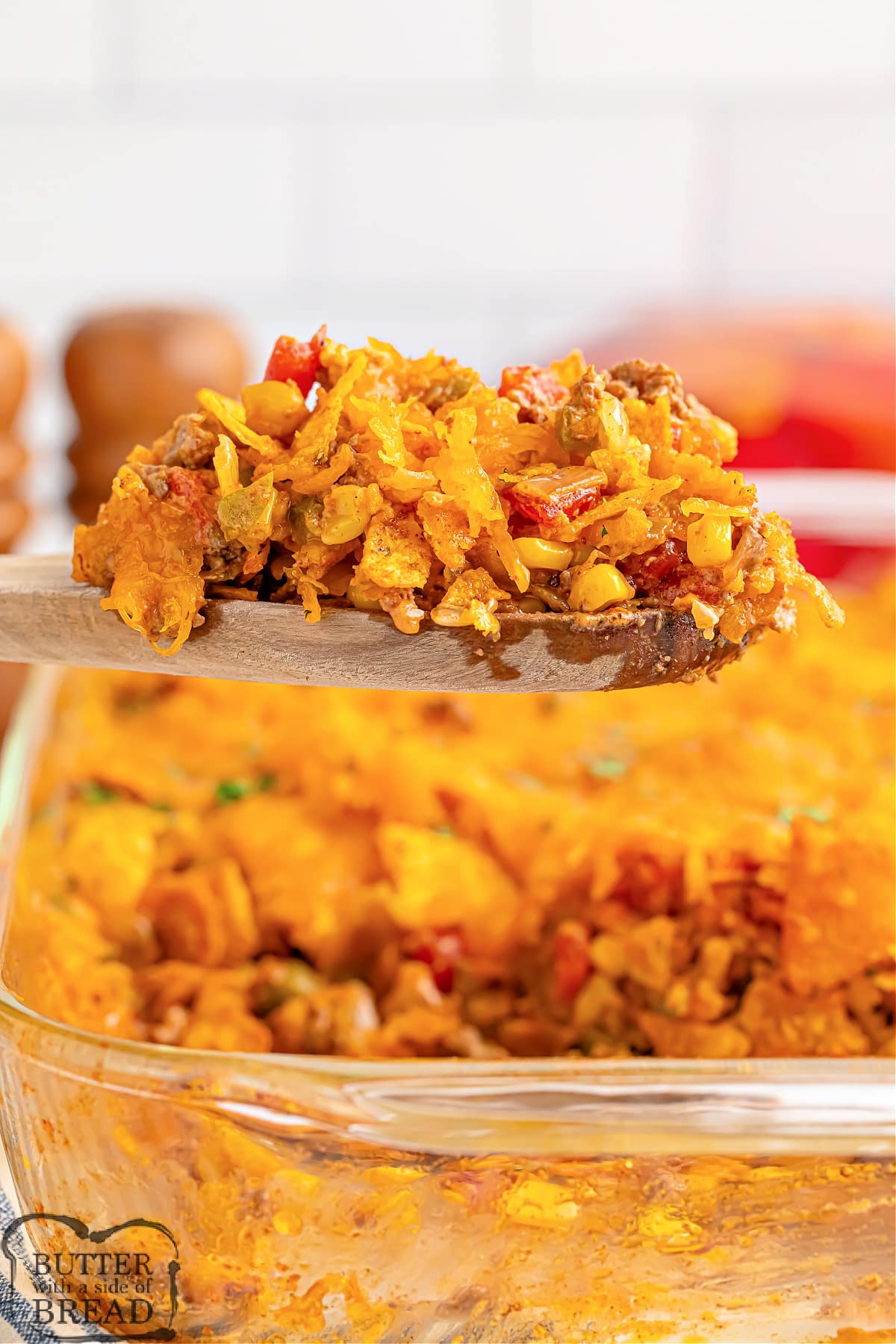 Dorito Taco Casserole made in less than 40 minutes is the perfect weeknight dinner recipe. Delicious casserole recipe made with ground beef, onion, tomatoes, corn, crushed Doritos, and cheese. 