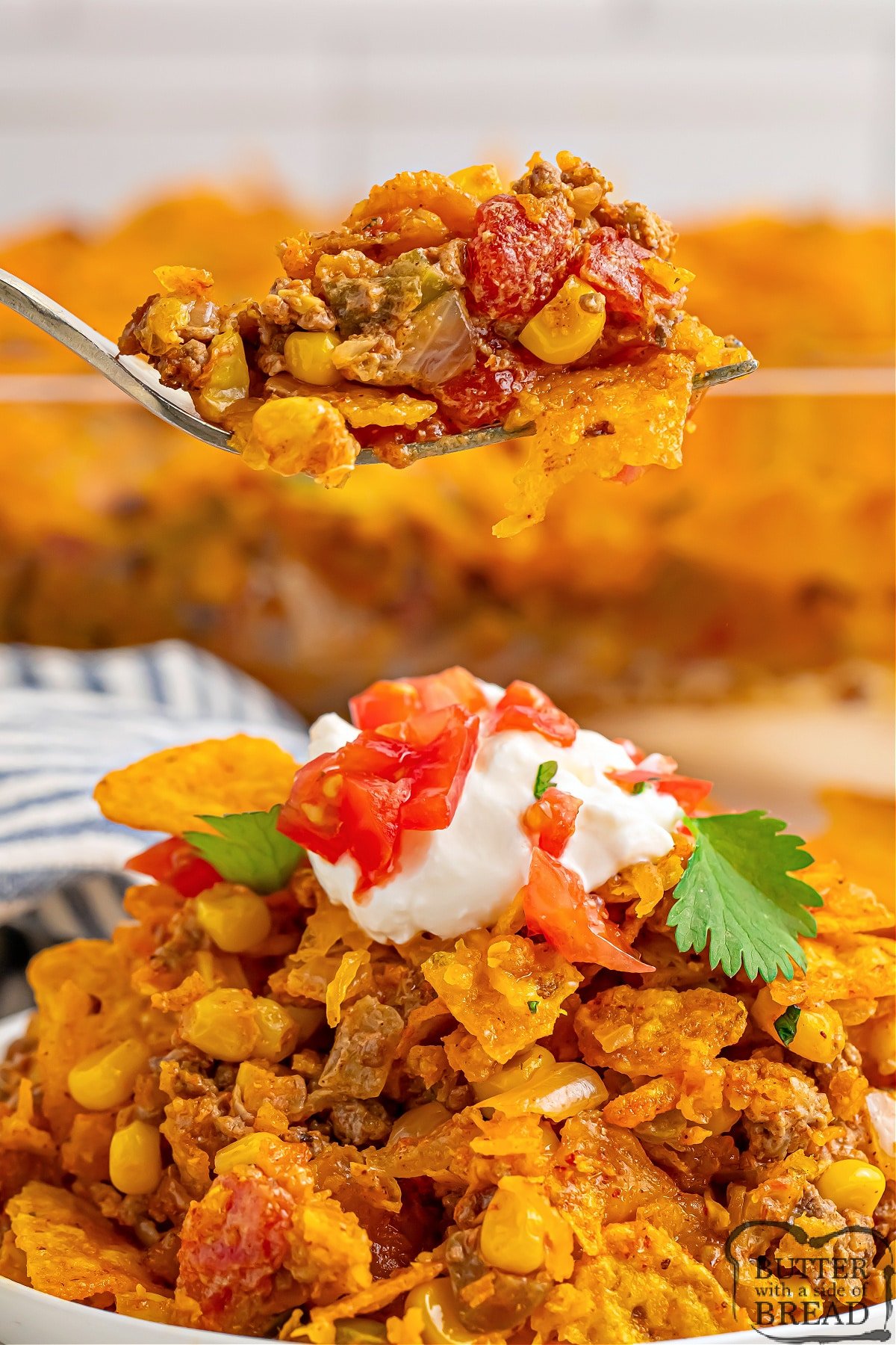 Dorito Taco Casserole made in less than 40 minutes is the perfect weeknight dinner recipe. Delicious casserole recipe made with ground beef, onion, tomatoes, corn, crushed Doritos, and cheese. 