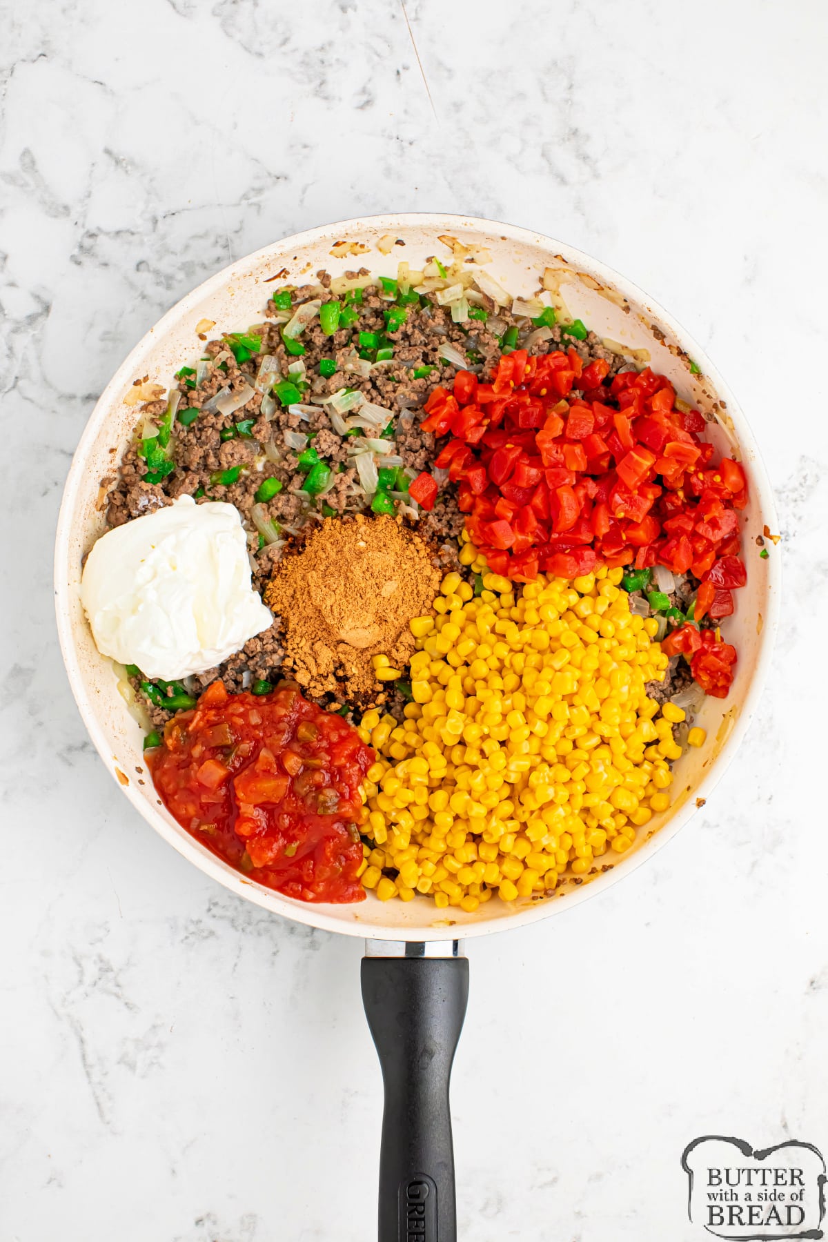 Add salsa, sour cream, corn, tomatoes, and taco seasoning to the cooked ground beef. 