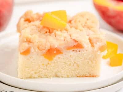 peach crumb cake on a white plate