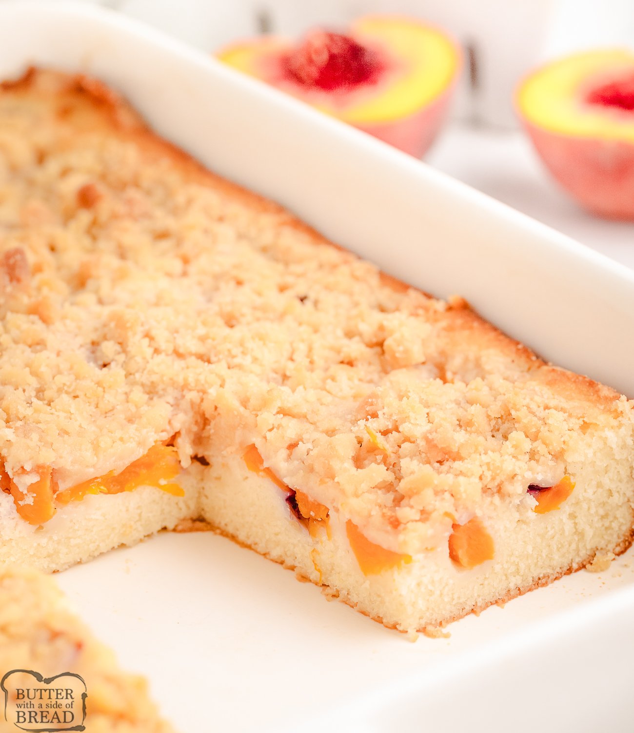 peach crumb cake in a white baking pan