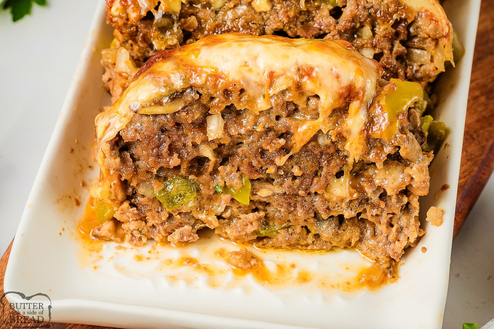 slice of philly cheesesteak meatloaf with provolone cheese on a plate