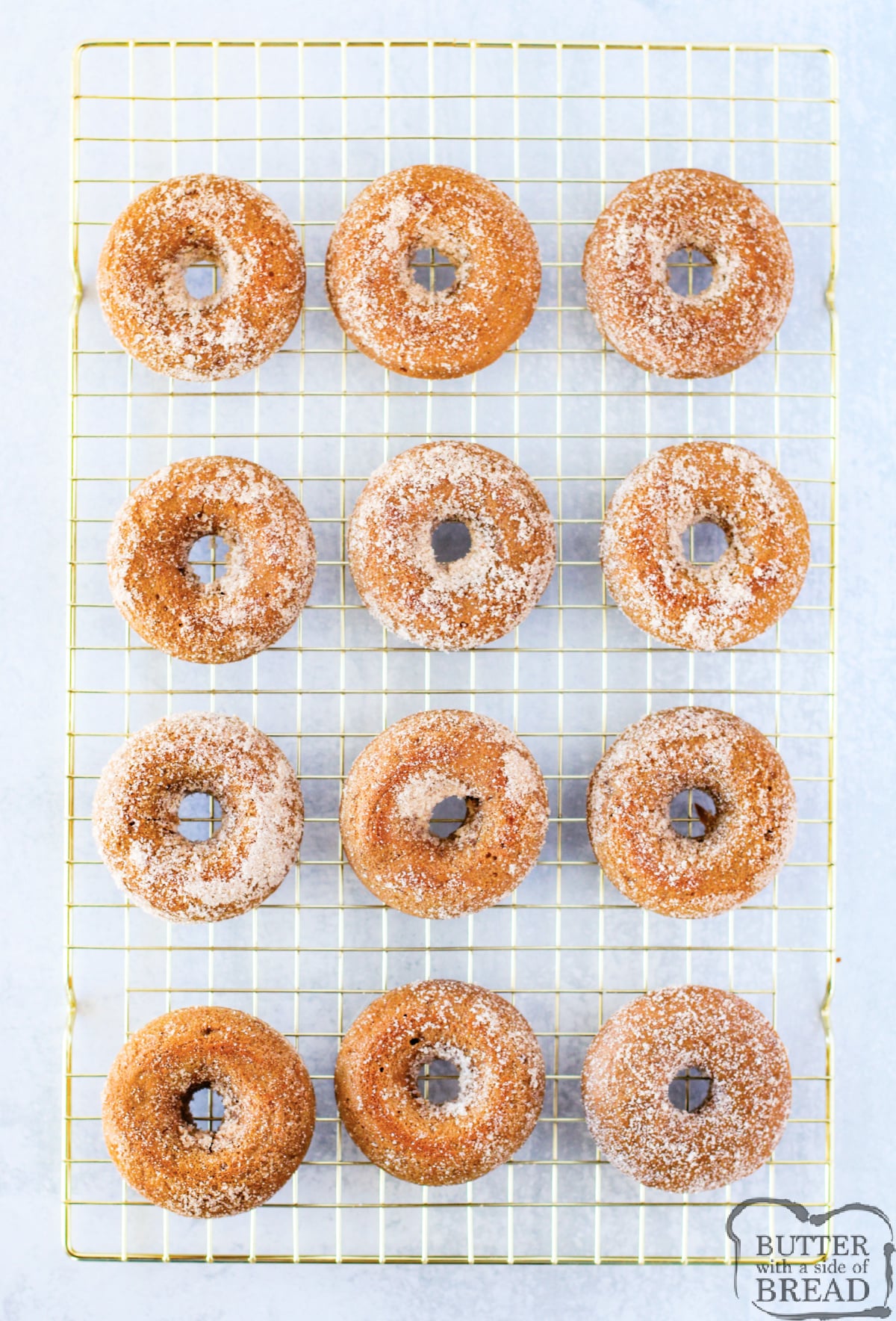 Coated donuts on wire rack.