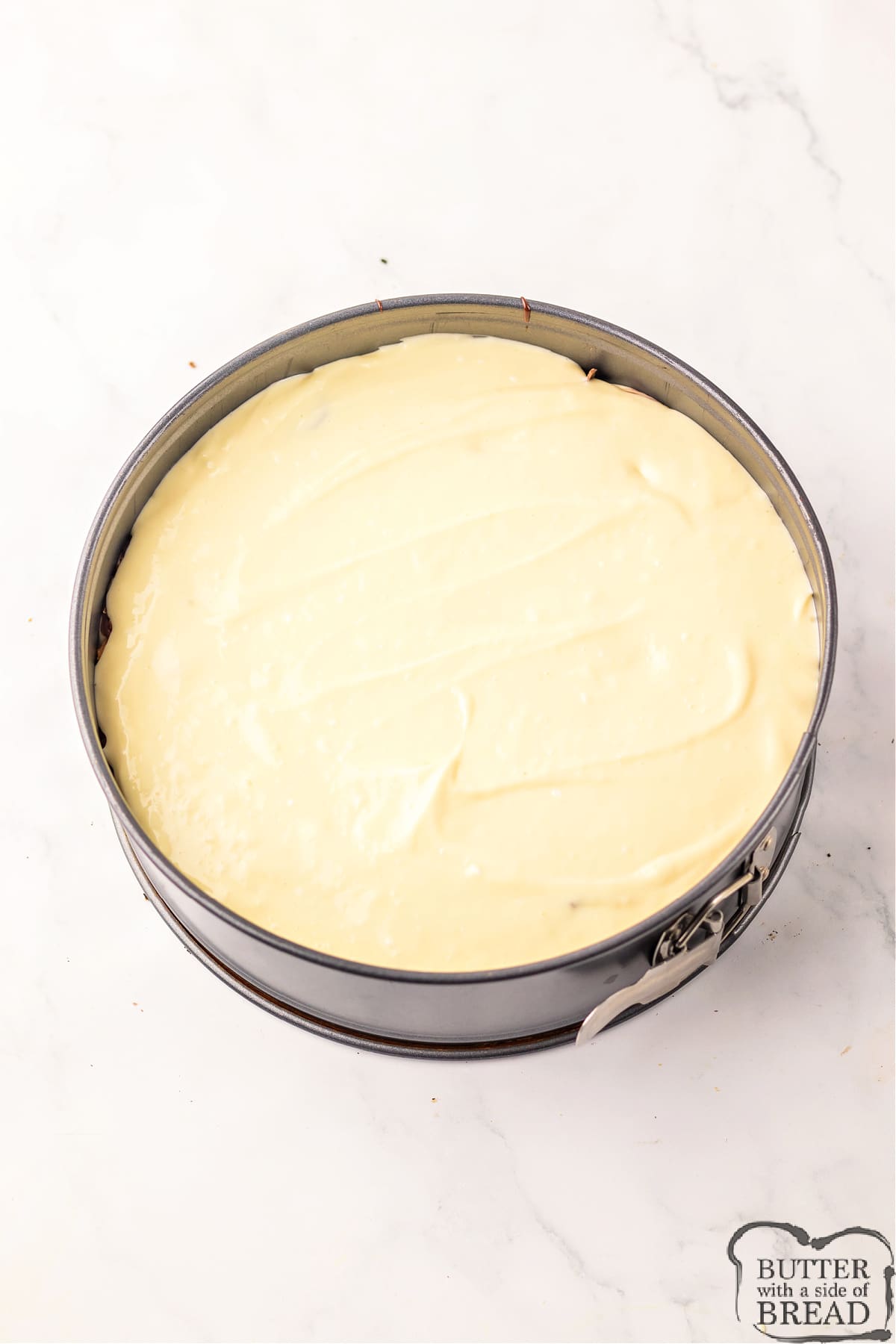 Add the remainder of the cheesecake filling to the springform pan. 