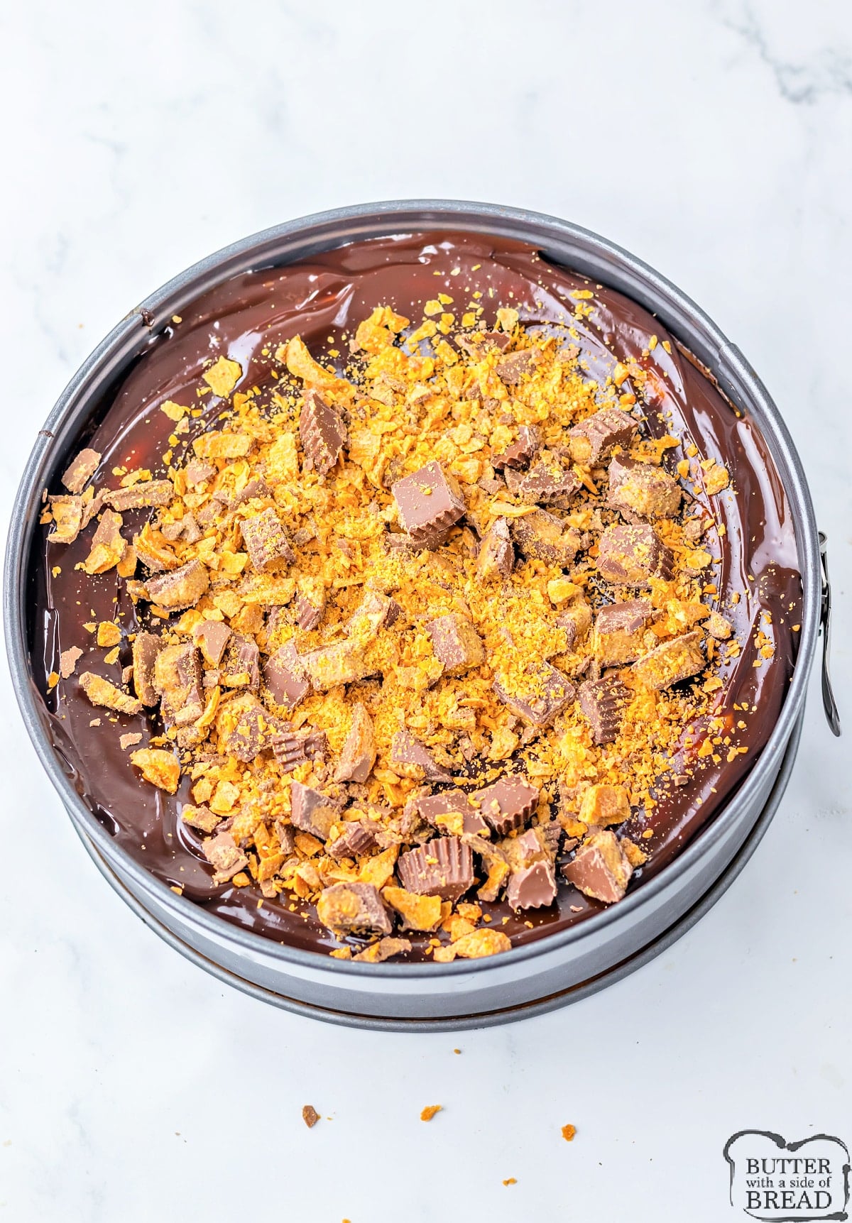 Add another layer of hot fudge, Reese's peanut butter cups, and Butterfinger candy bars on top. 