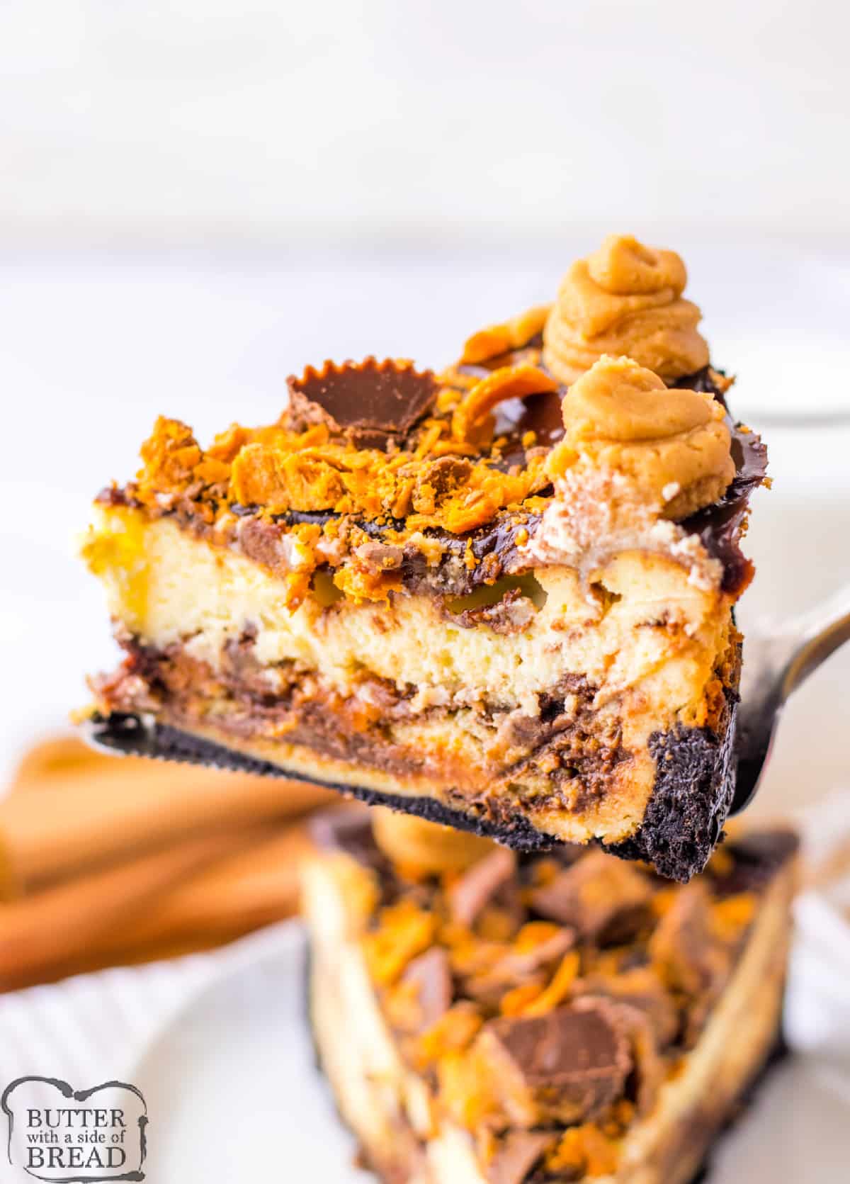 Copycat Cheesecake Factory Adam's Peanut Butter Cup Cheesecake is made with an Oreo crust, crushed Butterfingers, chopped peanut butter cups, and hot fudge. This decadent cheesecake is topped off with a peanut butter cream cheese frosting.