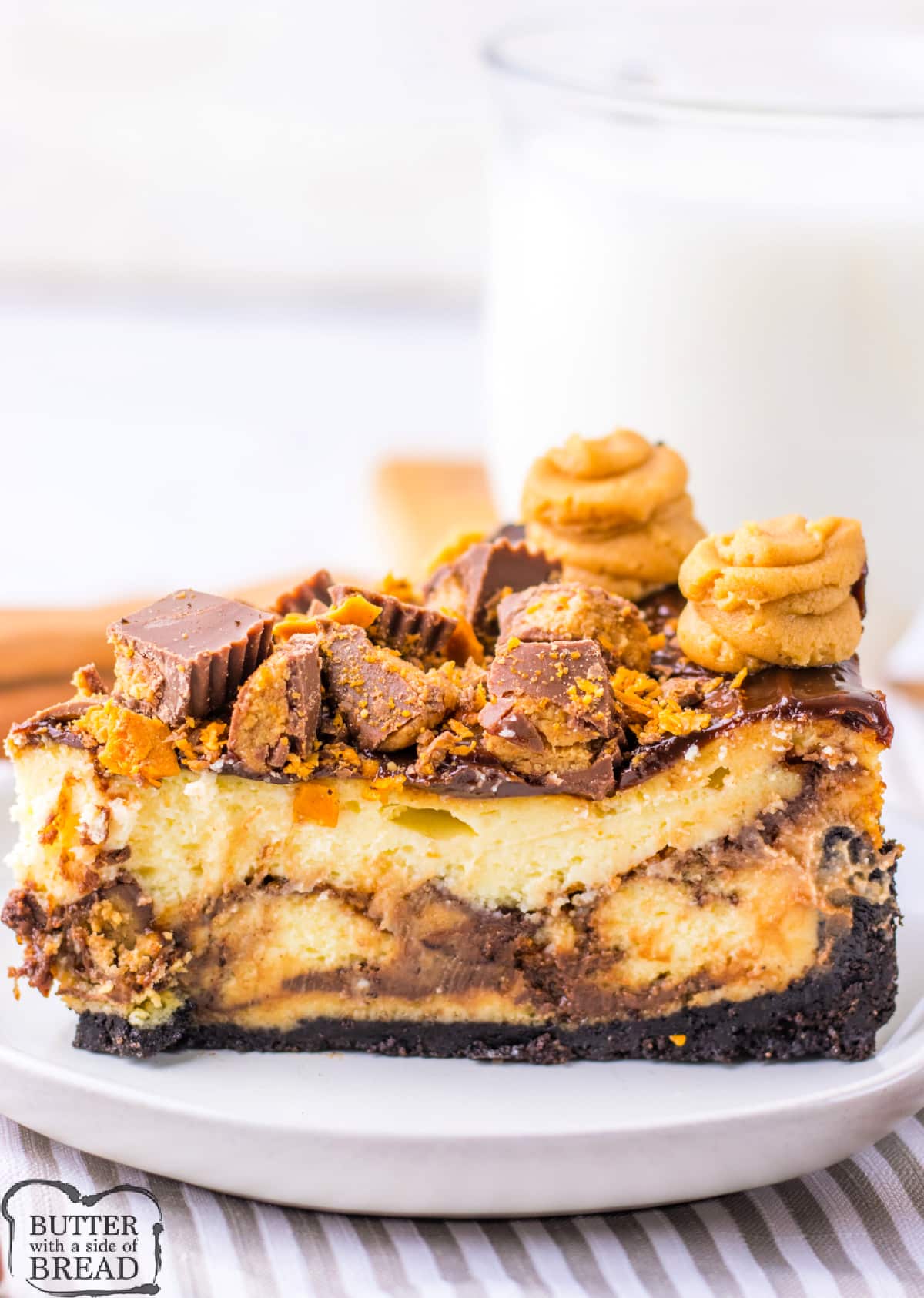 Copycat Cheesecake Factory Adam's Peanut Butter Cup Cheesecake is made with an Oreo crust, crushed Butterfingers, chopped peanut butter cups, and hot fudge. This decadent cheesecake is topped off with a peanut butter cream cheese frosting.