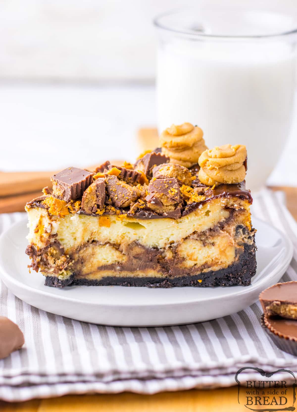 Copycat Cheesecake Factory Adam's Peanut Butter Cup Cheesecake is made with an Oreo crust, crushed Butterfingers, chopped peanut butter cups, and hot fudge. This decadent cheesecake is topped off with a peanut butter cream cheese frosting.