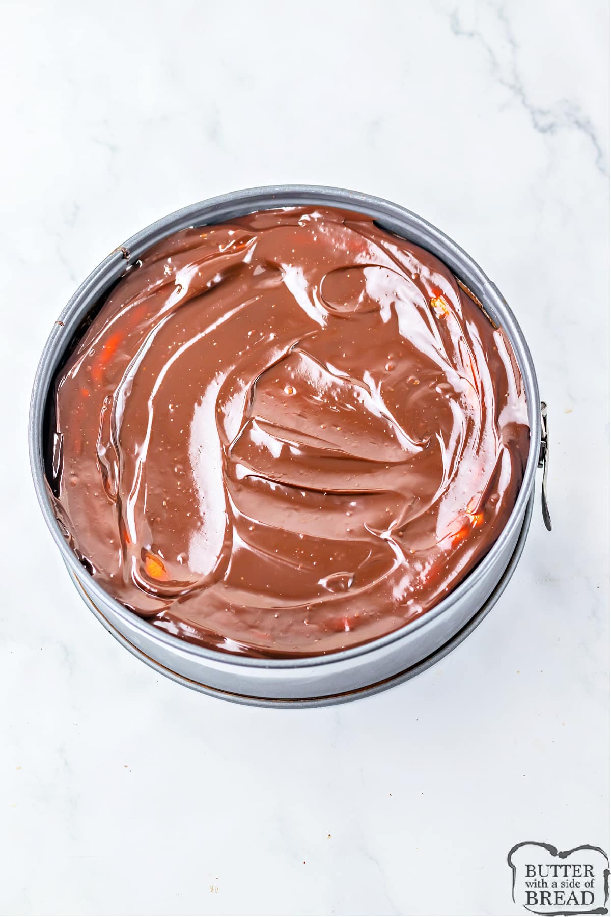 Spread hot fudge over cheesecake filling. 