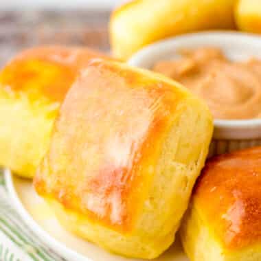 plateful of homemade square rolls brushed with butter