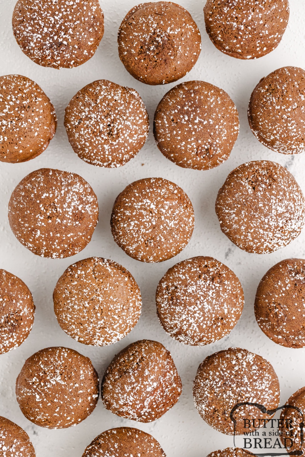 Gingersnap muffins with powdered sugar on top.