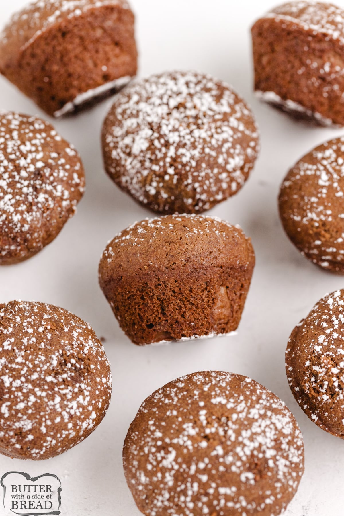 Gingerbread mini muffins with powdered sugar sprinkled on top.
