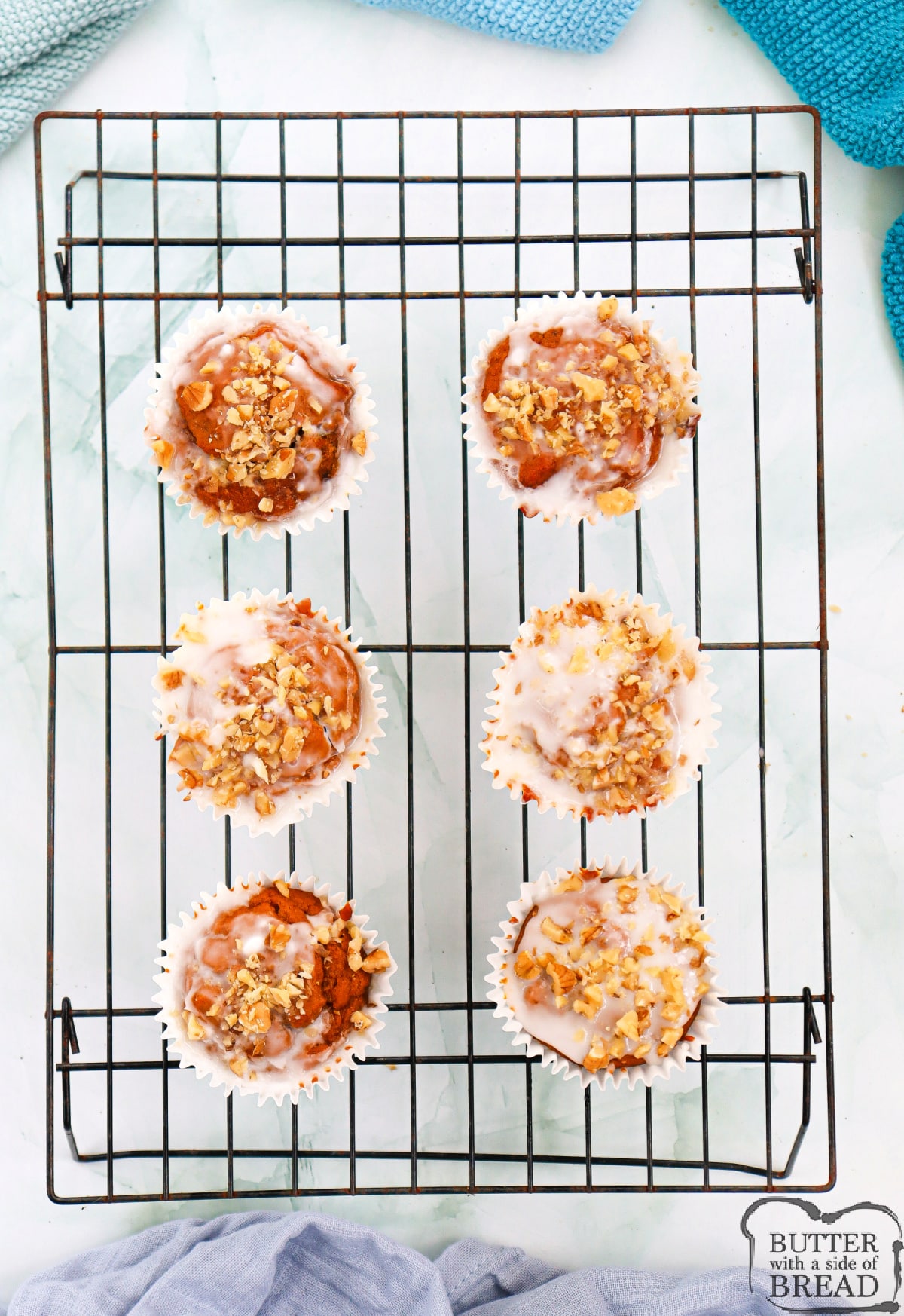 Sprinkle more chopped walnuts on top of the iced muffins.