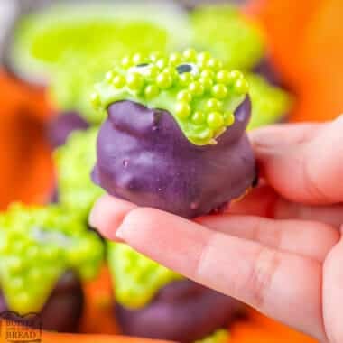 holding a festive Halloween cauldron Oreo Ball