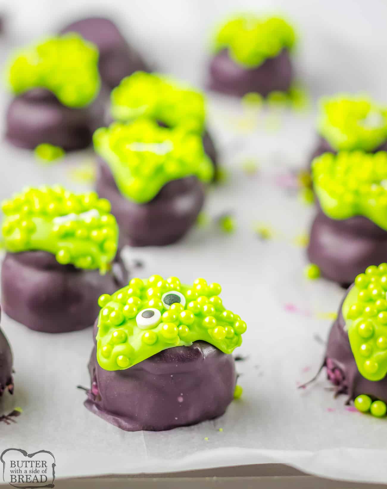 chocolate dipped Oreo Balls topped with green to look like mini cauldrons for Halloween