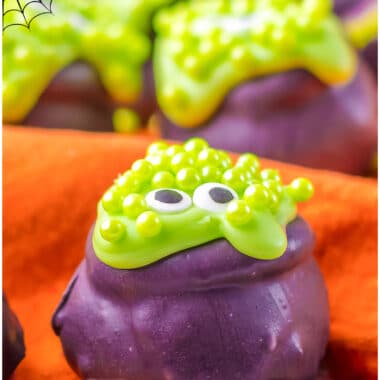 Spooky Cauldron Oreo Balls are the perfect Halloween treats for your little goblins! Festive Oreo truffles are dipped in green & purple, shaped into a cauldron & topped with chocolate & sprinkle "bubbles!"