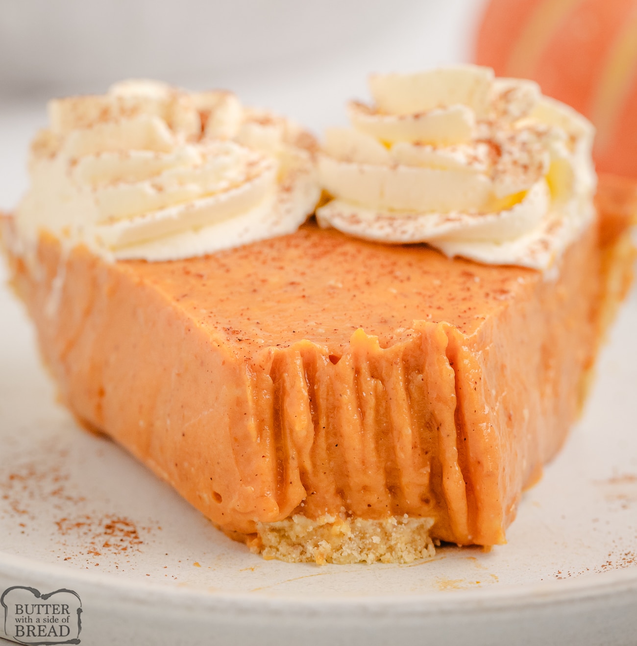 taking a bite of a slice of creamy pumpkin pie
