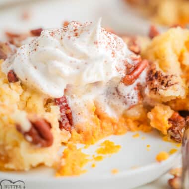 pumpkin dump cake with pecans and whipped cream