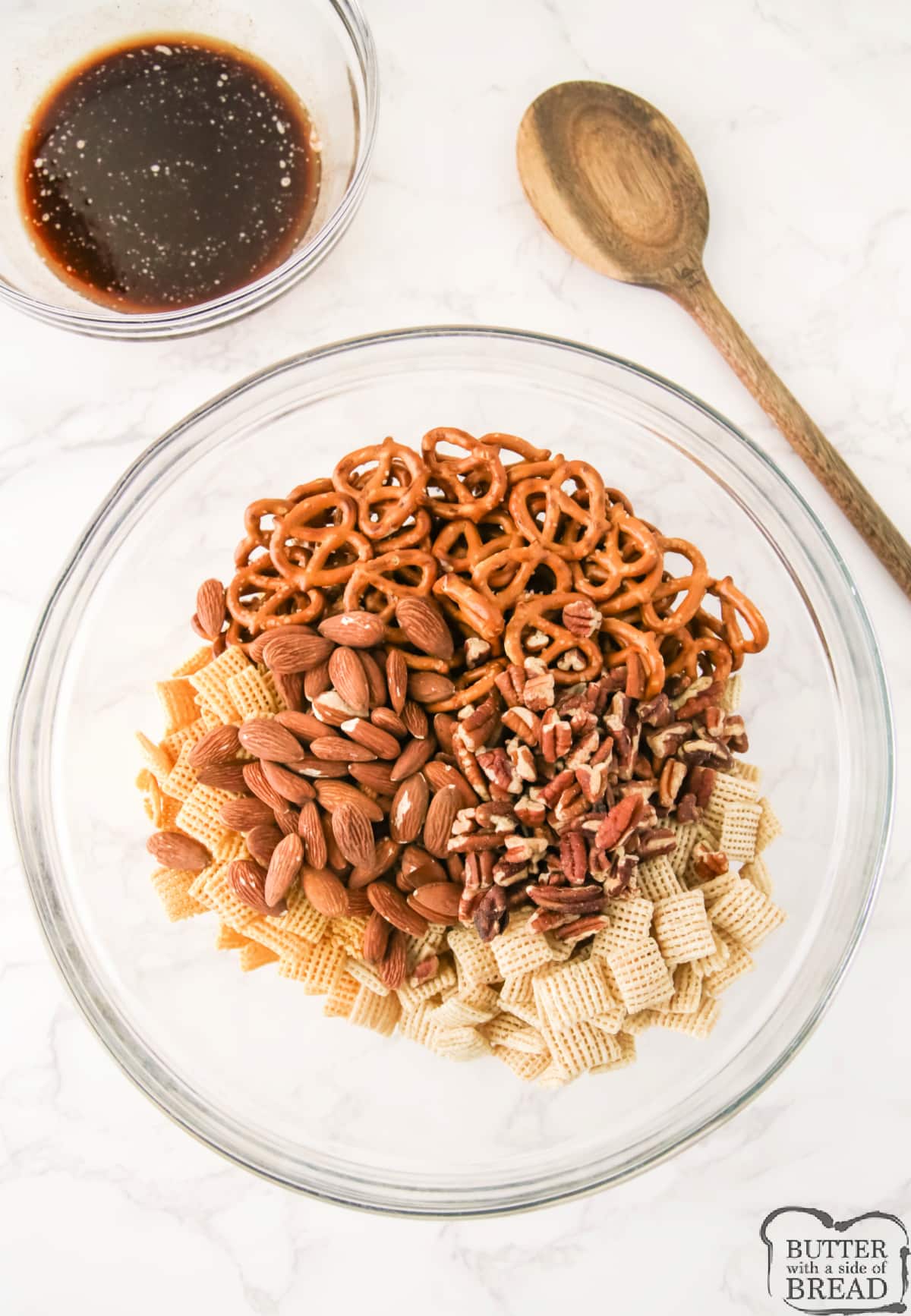 Chex cereals, pretzels, and nuts in a large bowl.