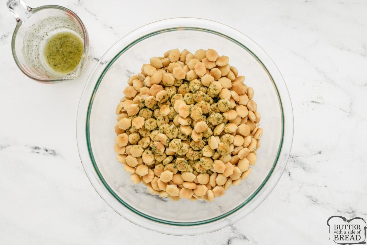 Pour oil and seasonings over bowl of oyster crackers.
