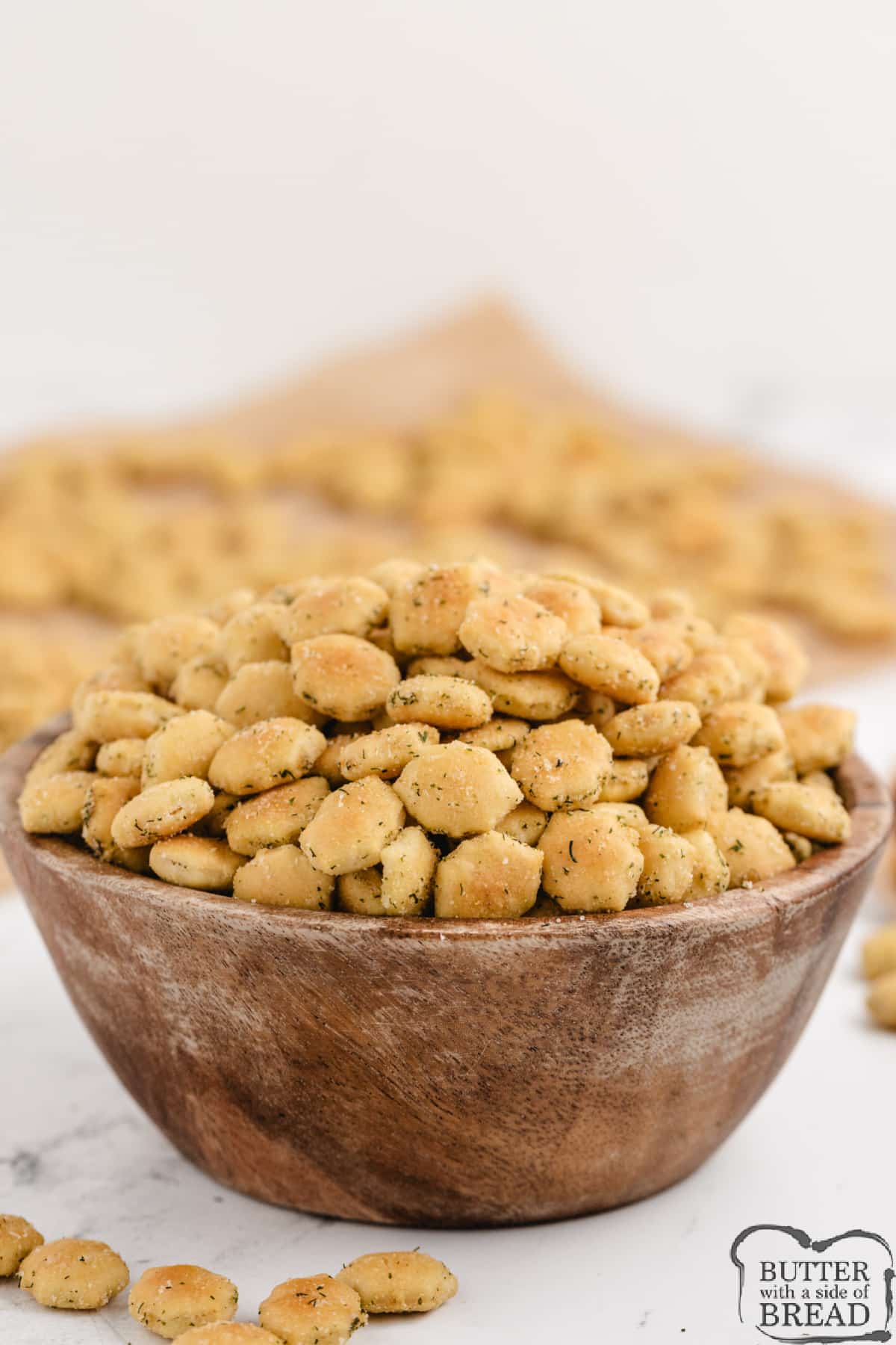 Bowl of snack crackers coated with olive oil and seasonings.