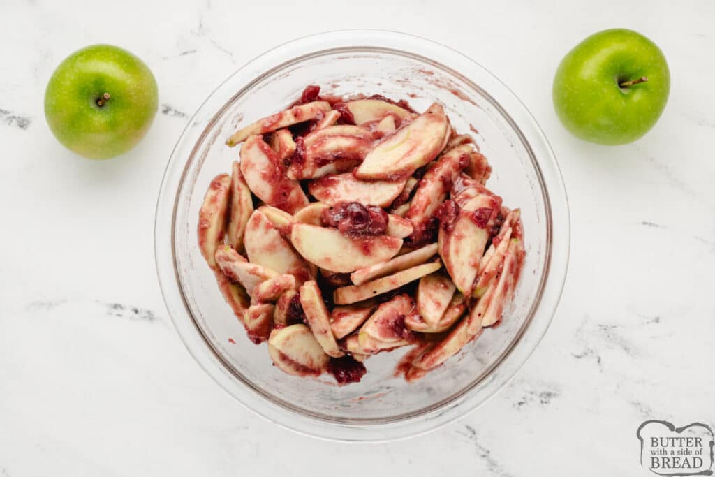 Sliced apples coated in cranberry mixture.