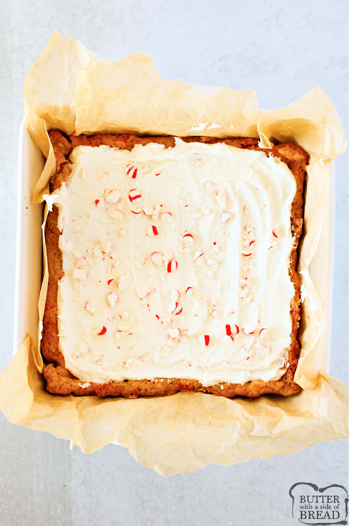Blondies frosted with buttercream frosting and topped with crushed peppermints.