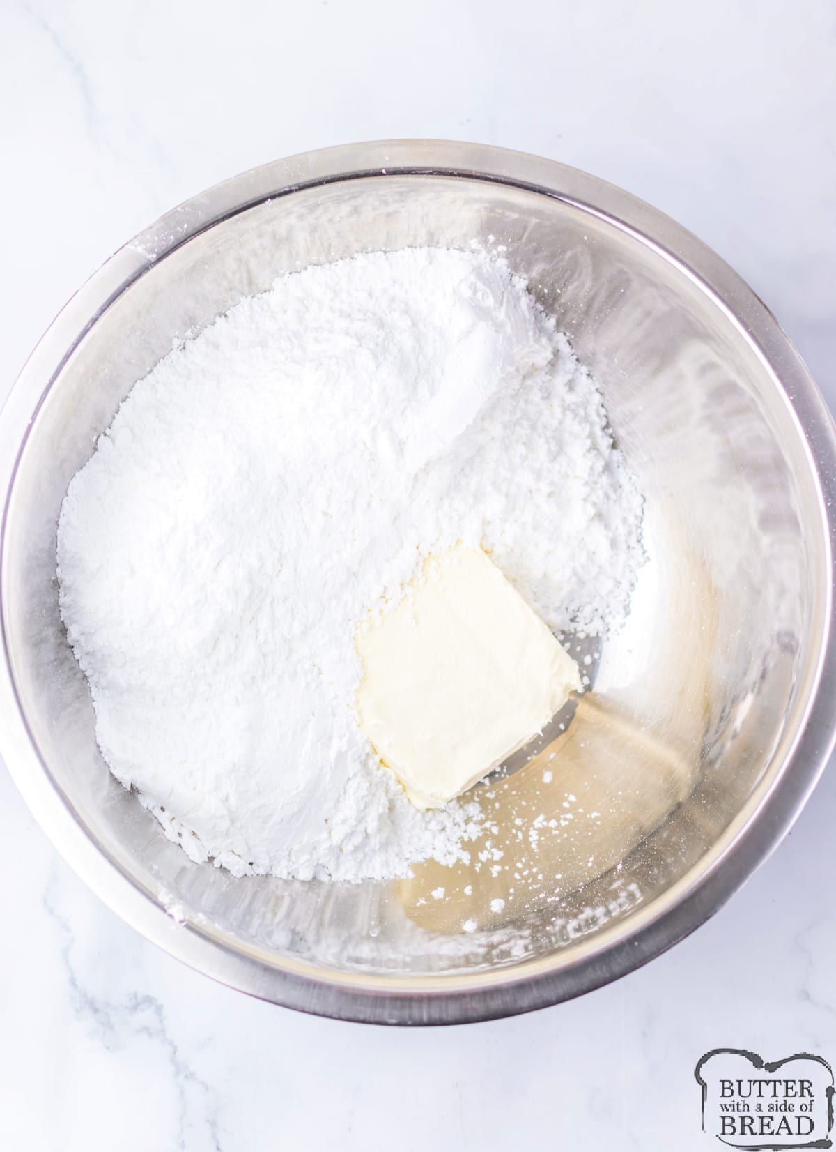 Mixing cream cheese and powdered sugar. 
