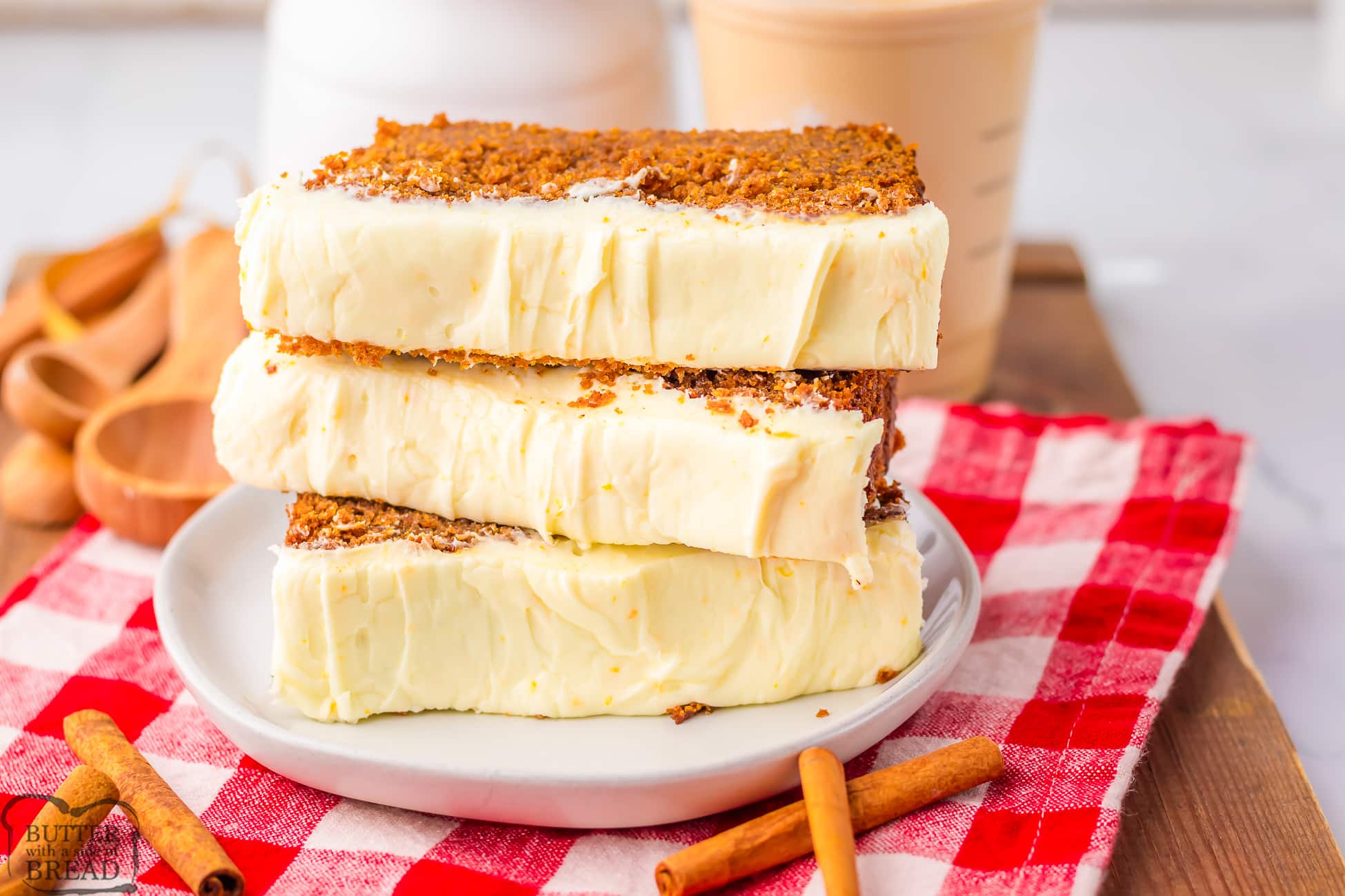 stack of slices of gingerbread loaf with thick cream cheese frosting