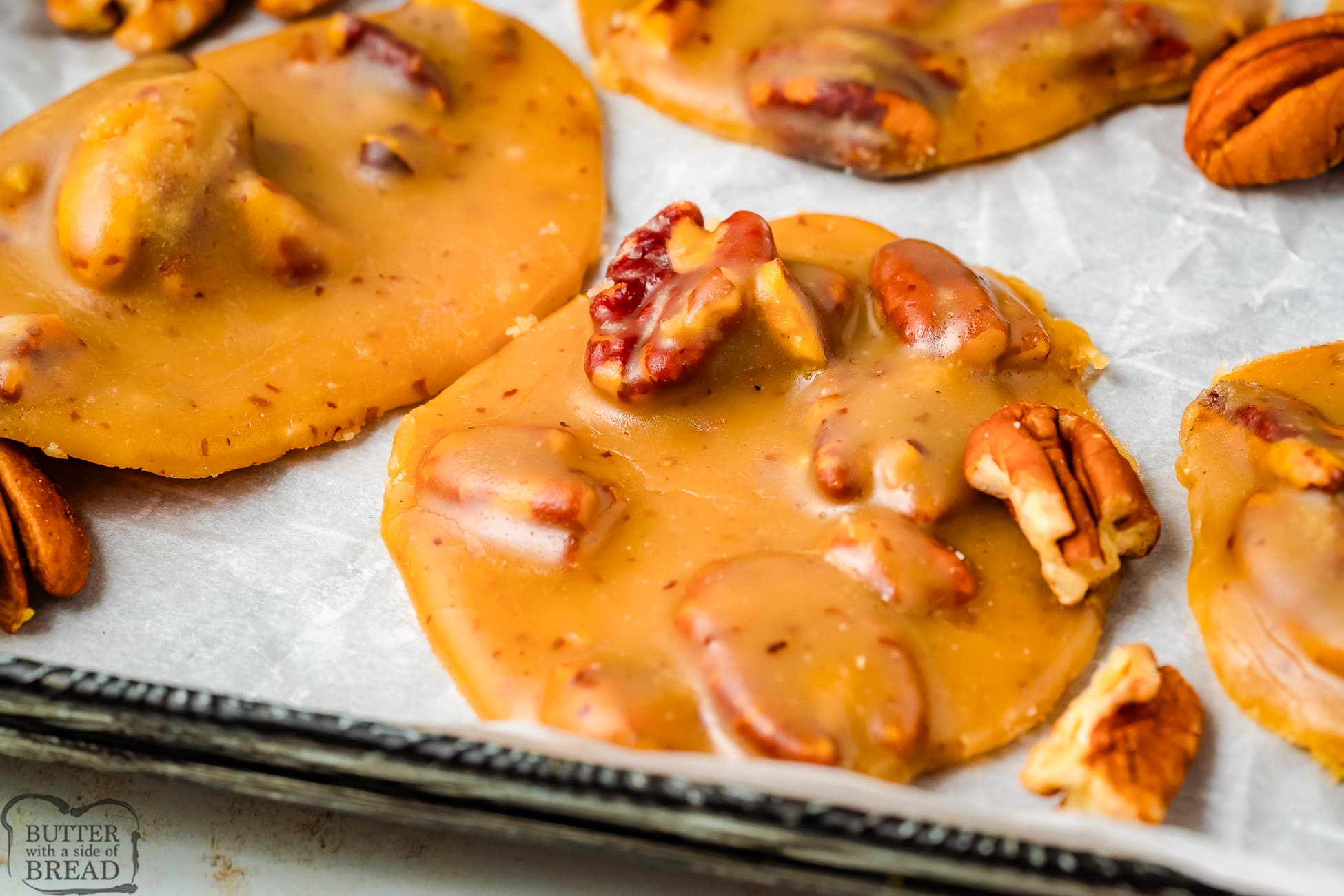 pecan pralines on parchment paper cooling