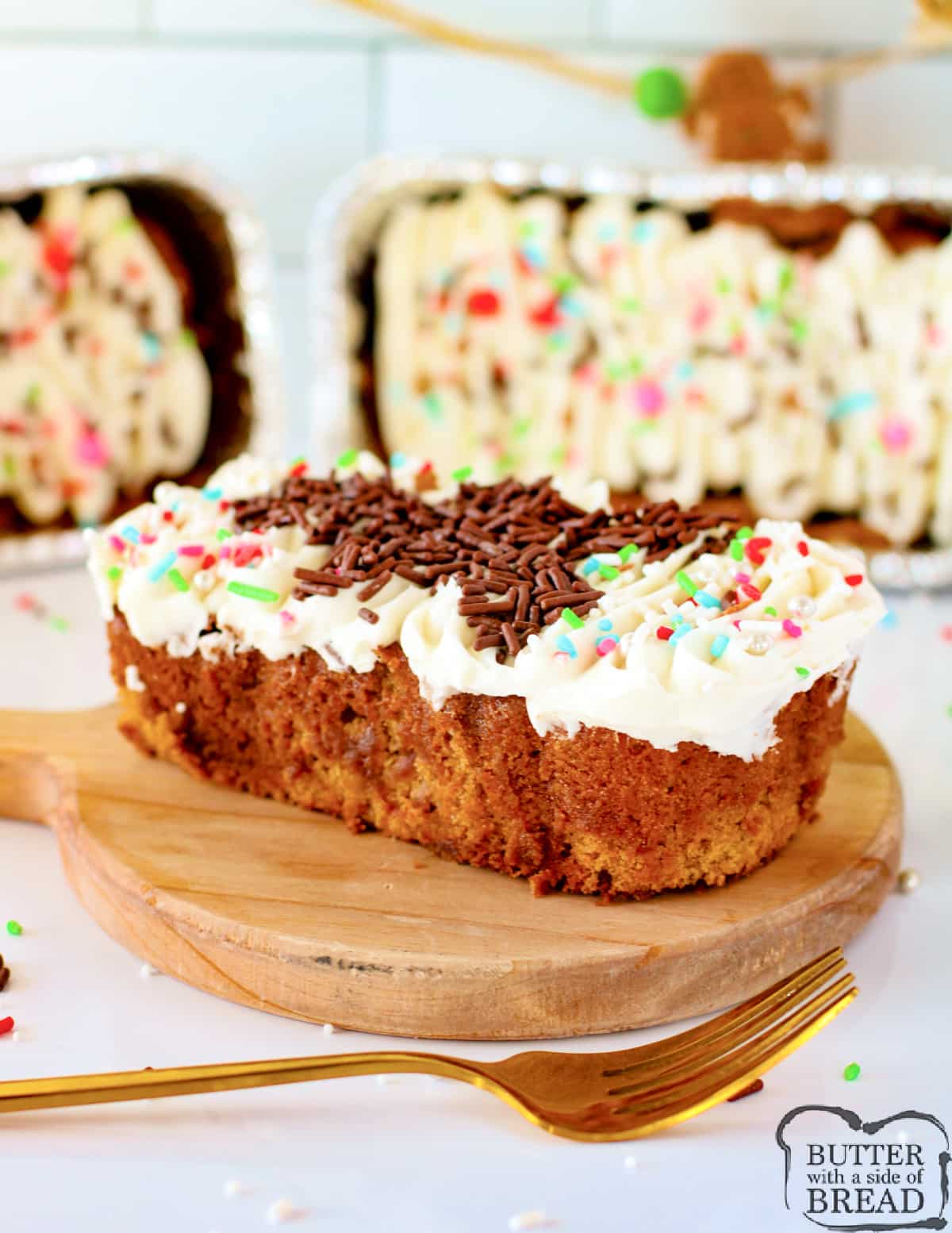 Mini gingerbread loaf with cream cheese frosting and sprinkles.