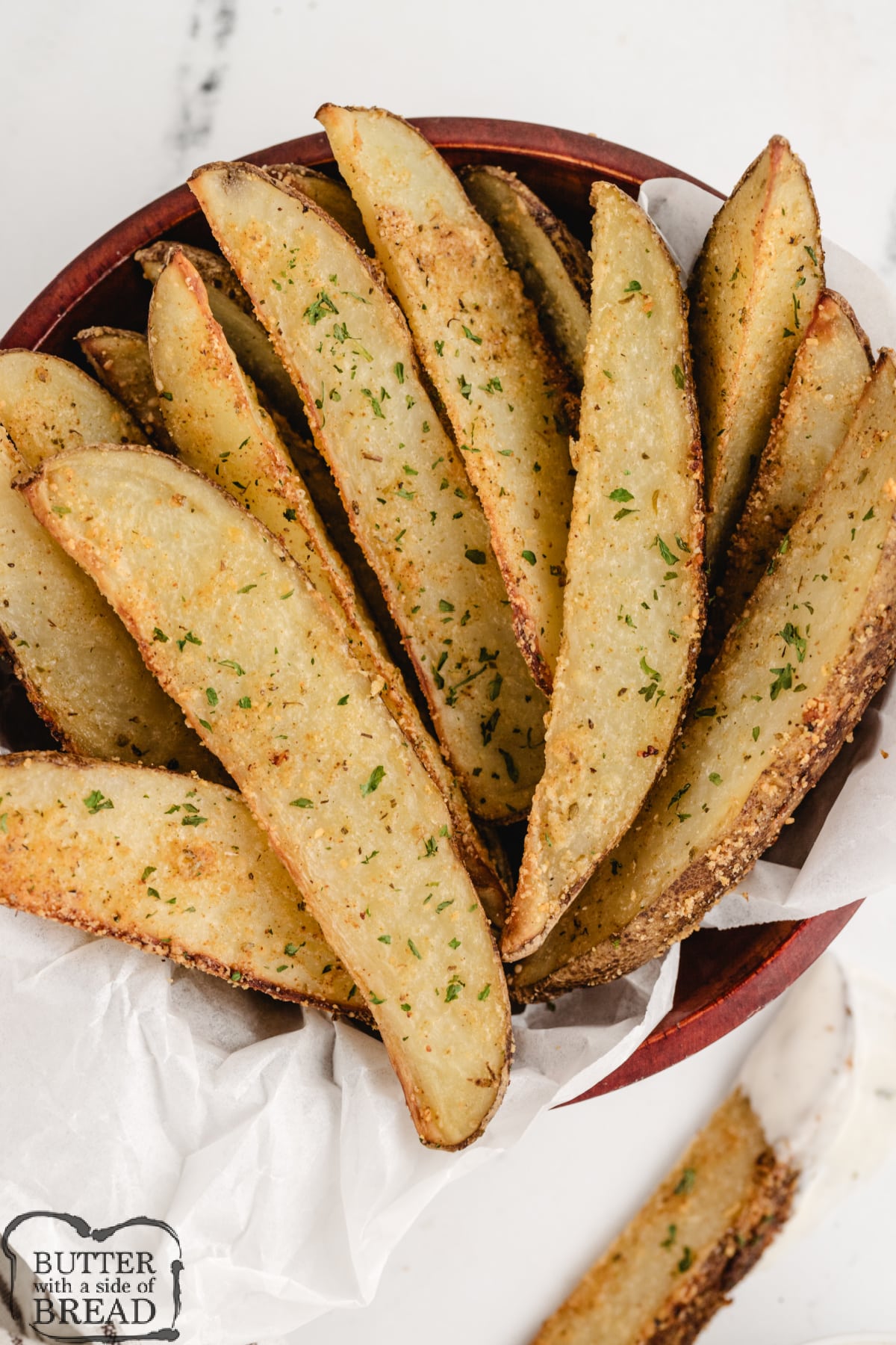 Baked Parmesan Potato Wedges are coated with parmesan cheese, garlic, oregano, and paprika. This simple potato recipe is perfect as a side dish or appetizer.