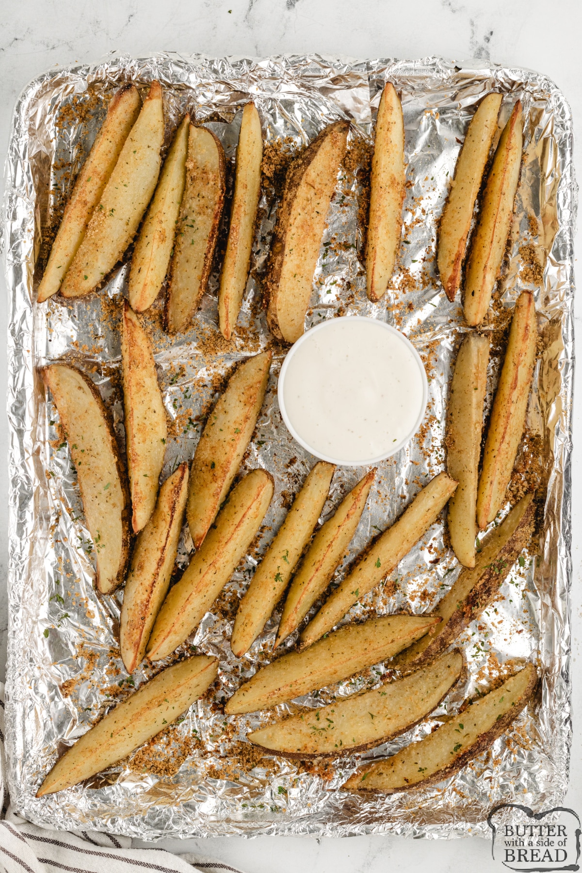 Baked Parmesan Potato Wedges are coated with parmesan cheese, garlic, oregano, and paprika. This simple potato recipe is perfect as a side dish or appetizer.