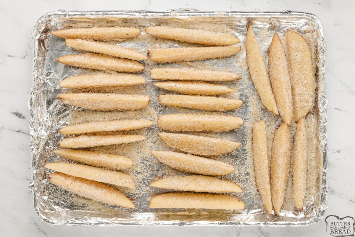 Coat potato wedges with olive oil, parmesan cheese, and spices.