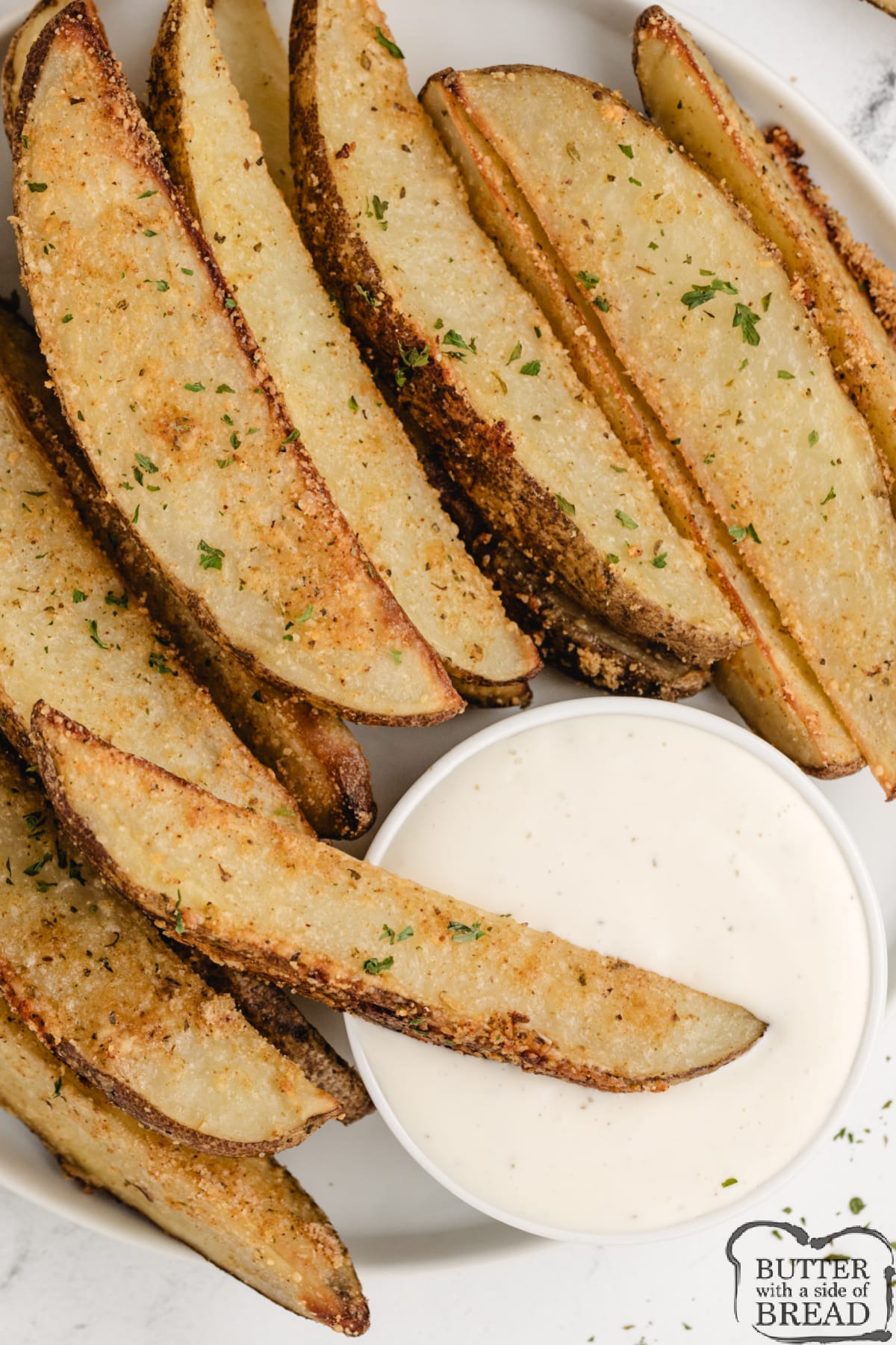 Baked Parmesan Potato Wedges with ranch dressing. 