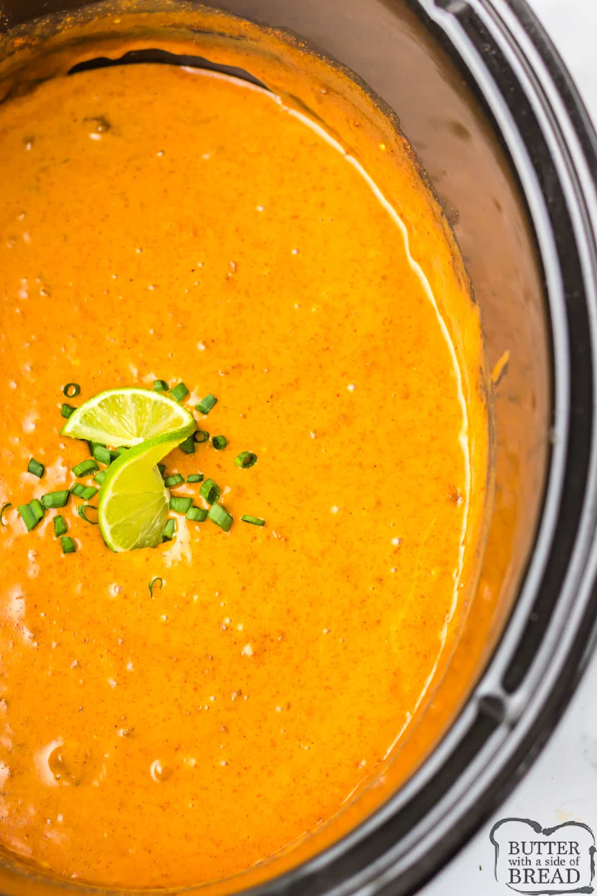 Copycat Chili's Queso Dip is so easy to make in the slow cooker! This simple chip dip is made with Velveeta cheese, canned chili, a few simple spices, and a splash of lime.