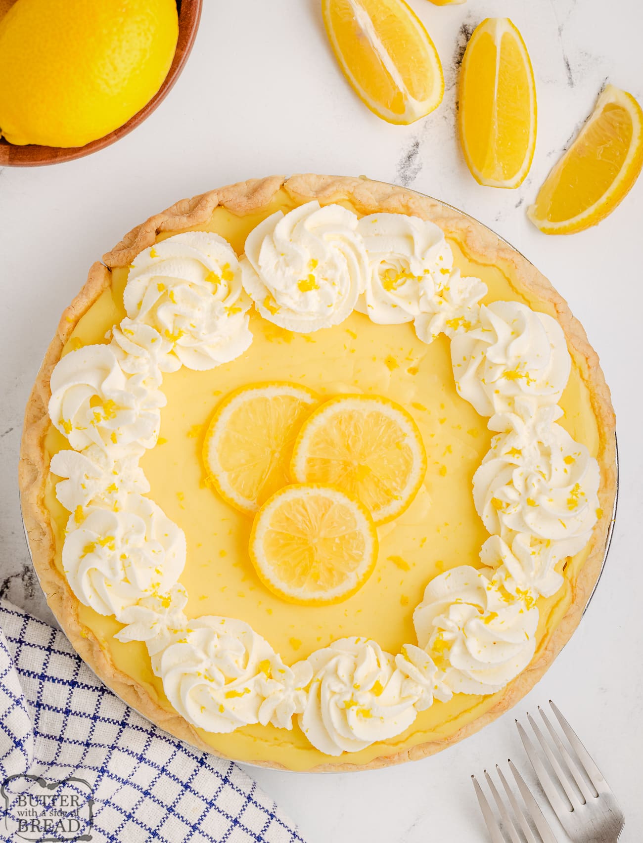 Fresh lemon pie topped with whipped cream and lemon slices