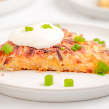 crispy hash browns stuffed with cheddar cheese topped with sour cream and green onions
