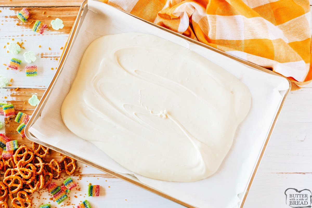 Melted white chocolate spread on parchment paper.