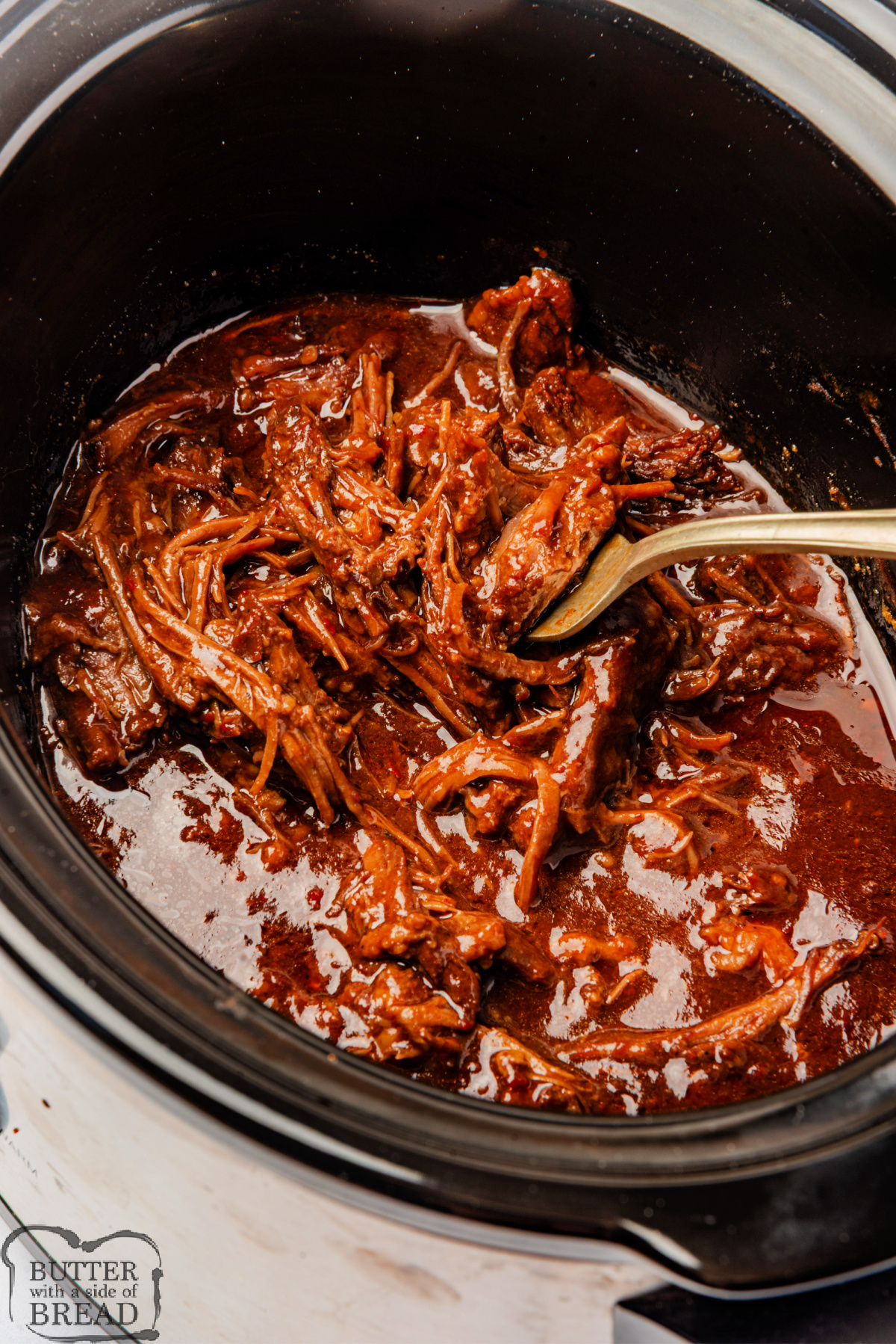 Cooked BBQ brisket in a crockpot.