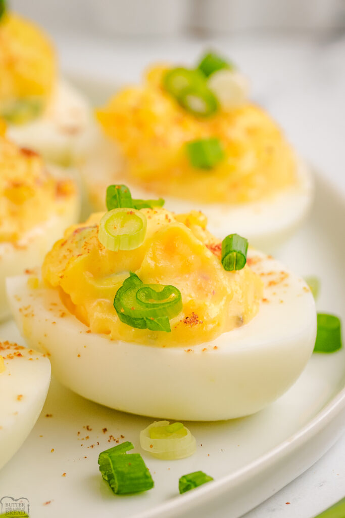 chipotle deviled eggs topped with green onions and smoked paprika