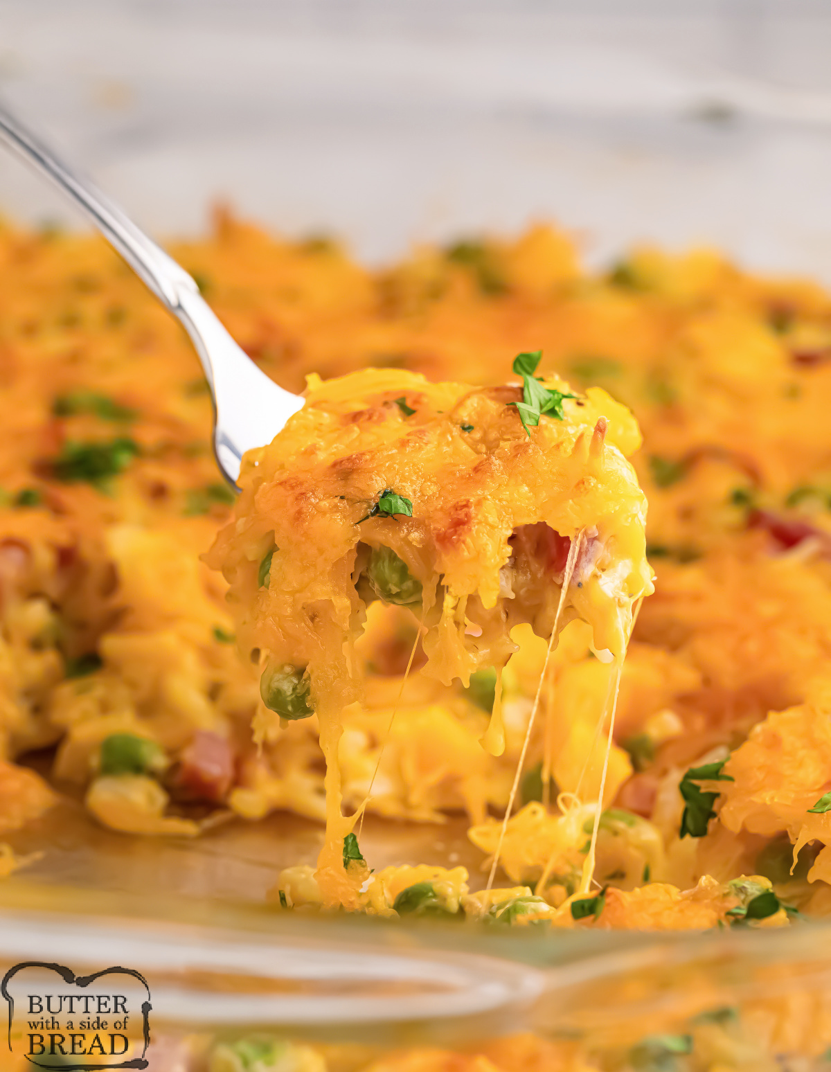 Cheesy Ham and Pea Casserole is made with rice, diced ham, peas, and shredded cheddar cheese. This flavorful casserole is an easy weeknight dinner recipe that the whole family will love.