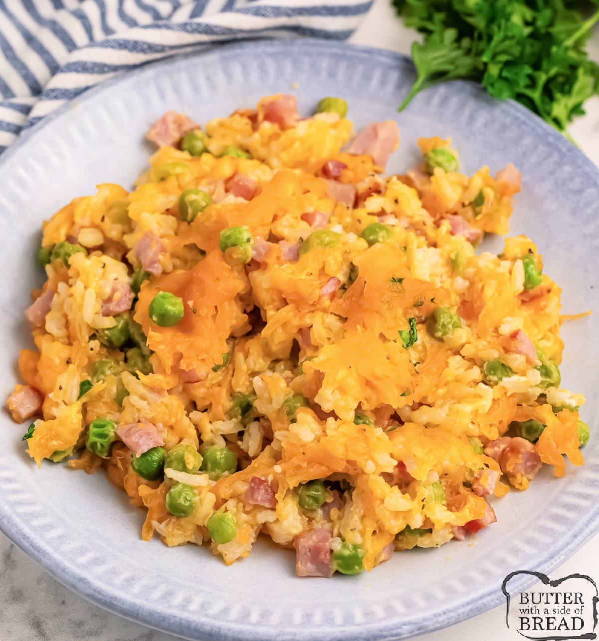 Cheesy Ham and Pea Casserole is made with rice, diced ham, peas, and shredded cheddar cheese. This flavorful casserole is an easy weeknight dinner recipe that the whole family will love.